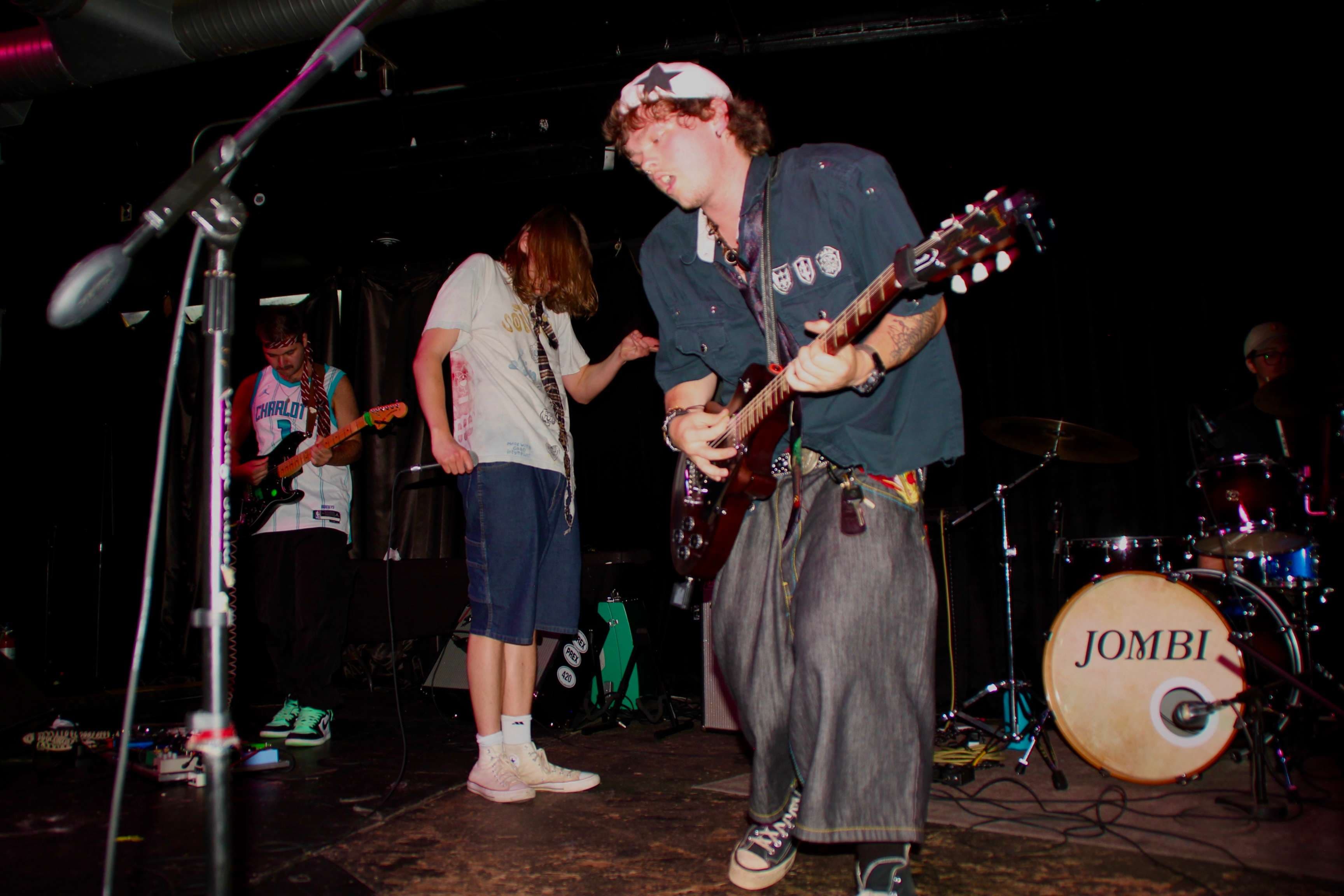 a man playing a guitar on stage